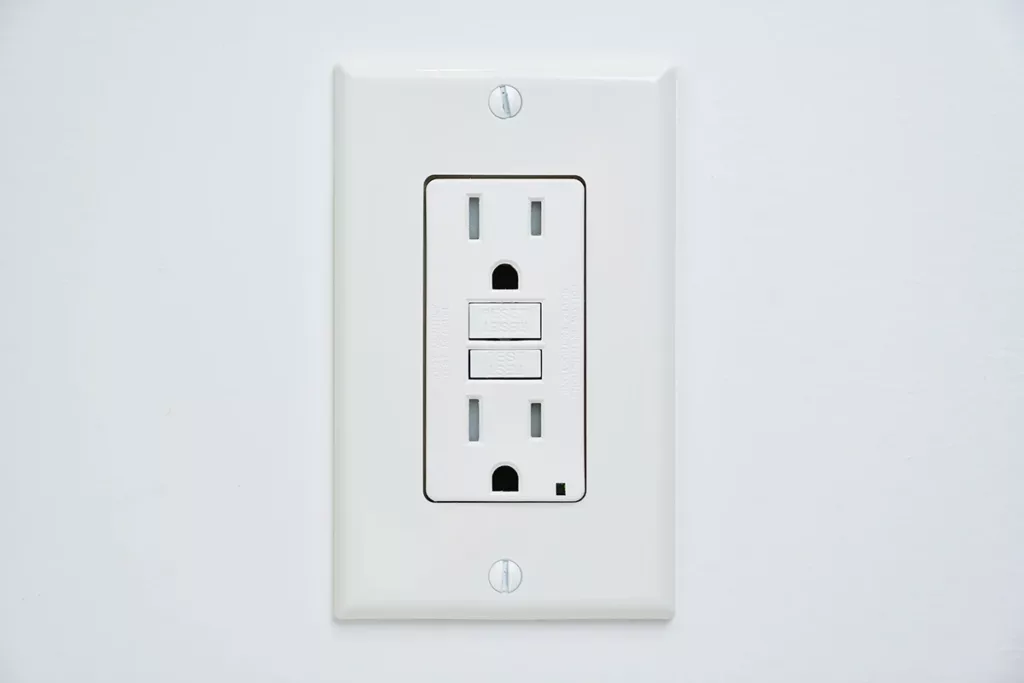 A GFCI outlet installed in a white wall